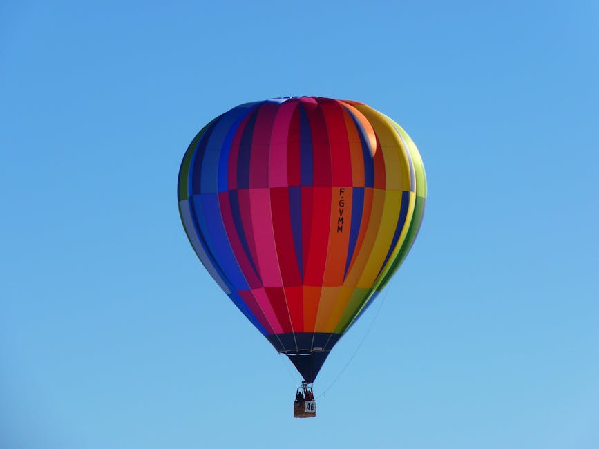 Colorful hot air balloon soaring high in a clear blue sky, capturing a sense of adventure and freedom.