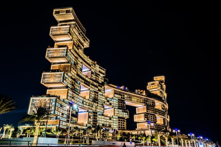 Stunning view of the illuminated Atlantis The Royal Hotel in Dubai, showcasing its modern architecture against the night sky.